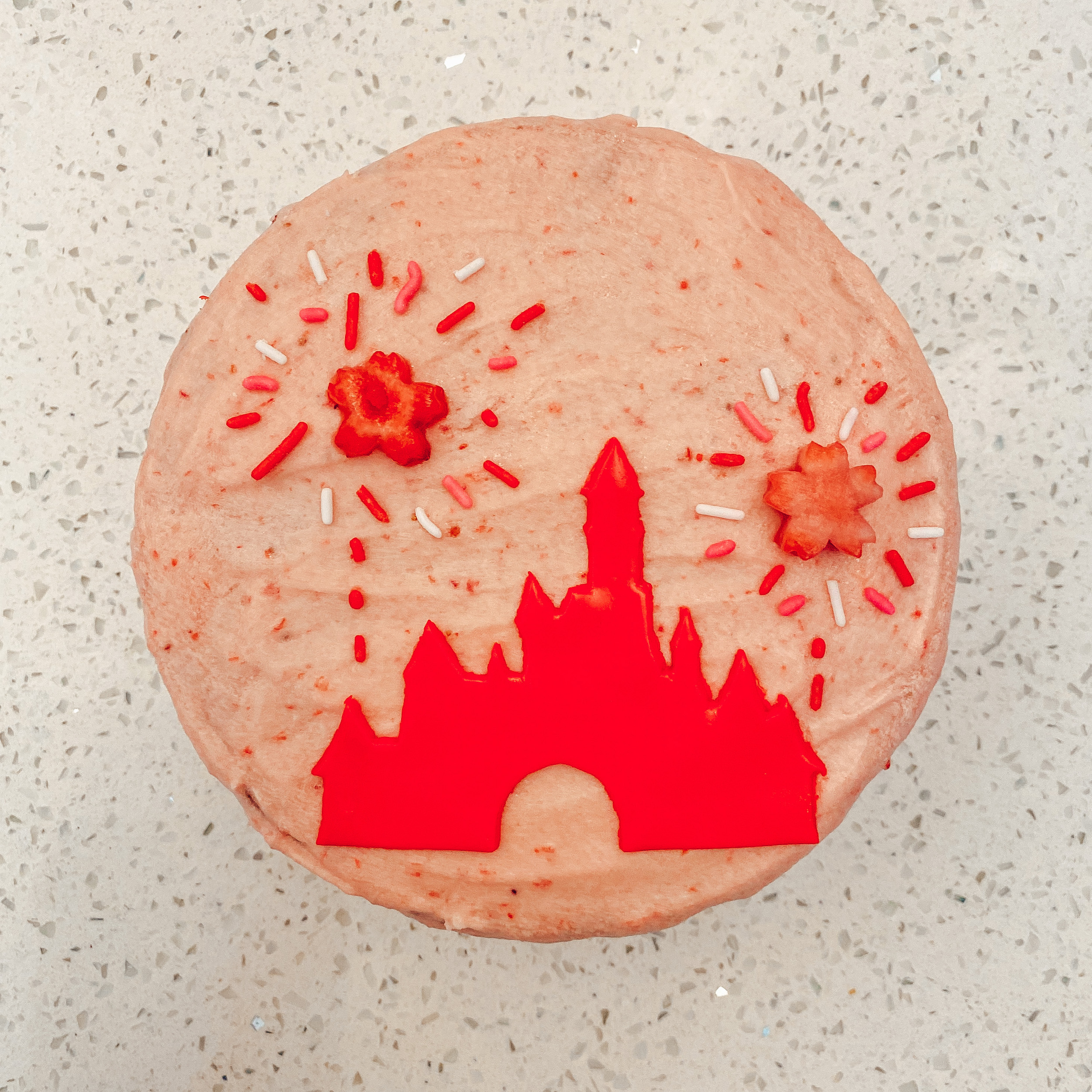 strawberry lemon cake with disneyland castle and fireworks decorations