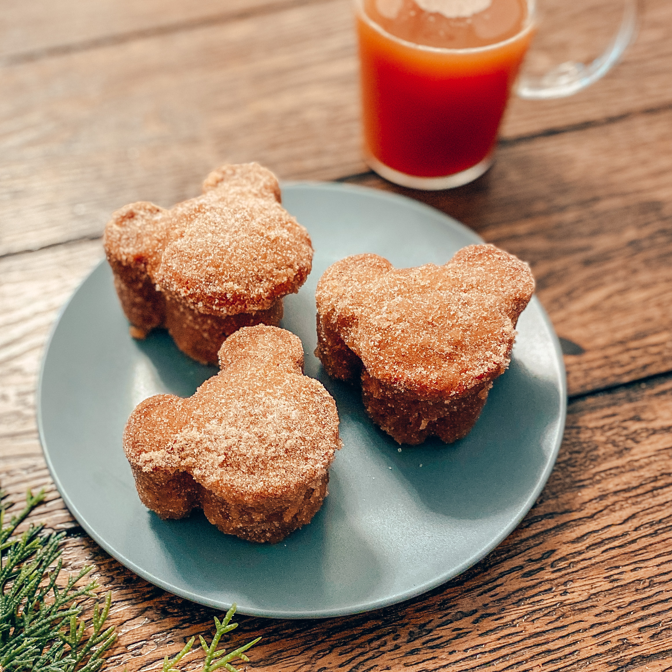 apple cider mickey muffins with a glass of apple cider