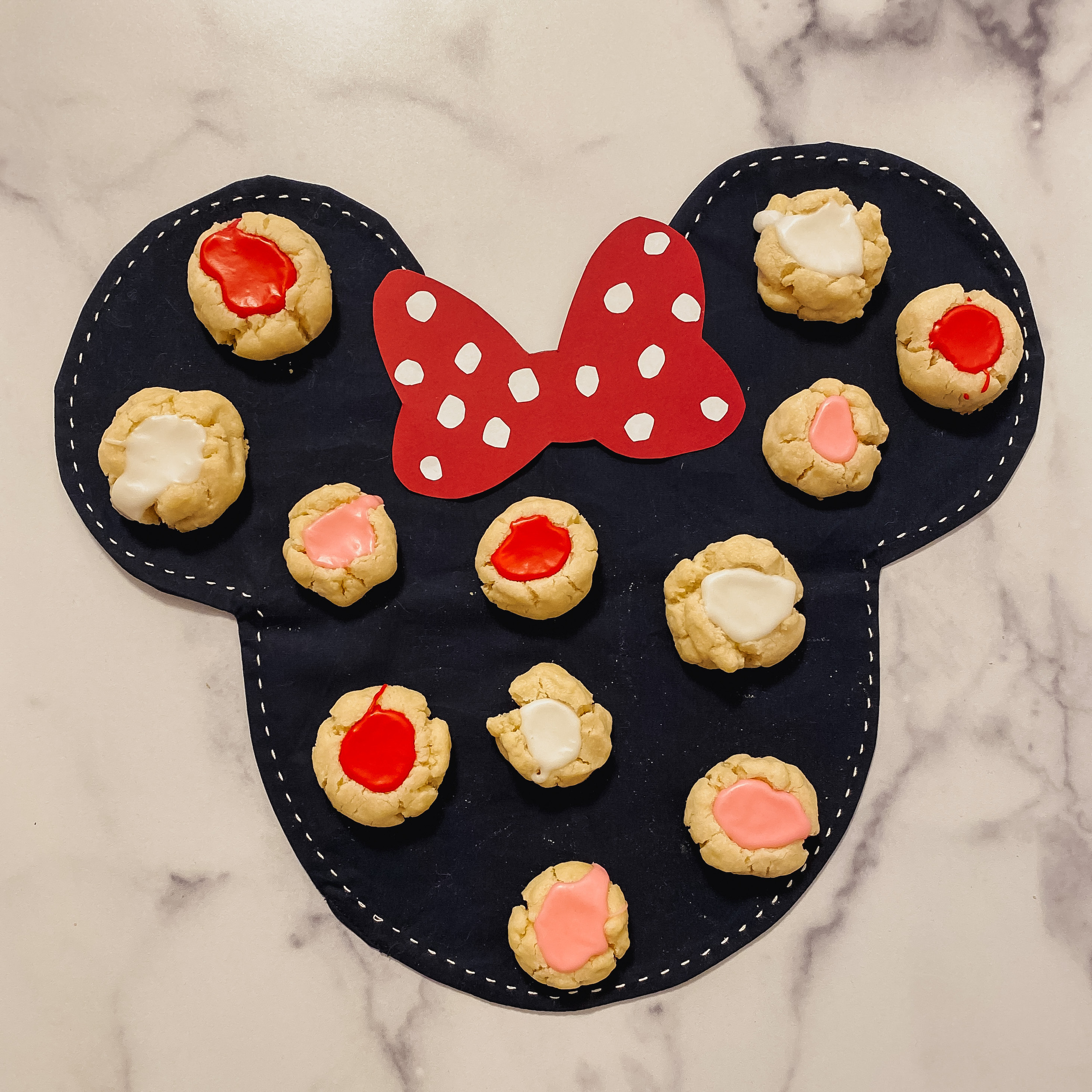 minnie's polka dot cookies. shortbread cookies with red, white, and pink icing