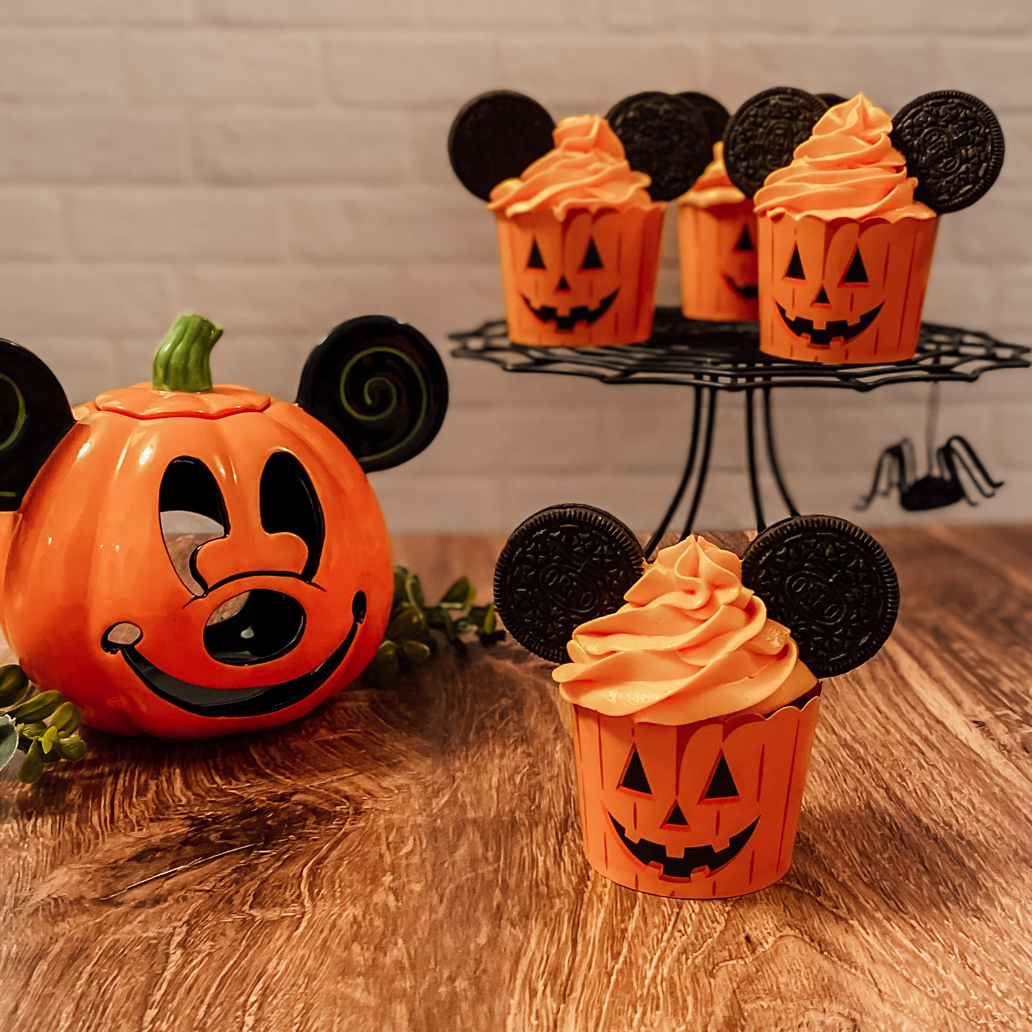 Pumpkin Mickey cupcakes on a cake stand