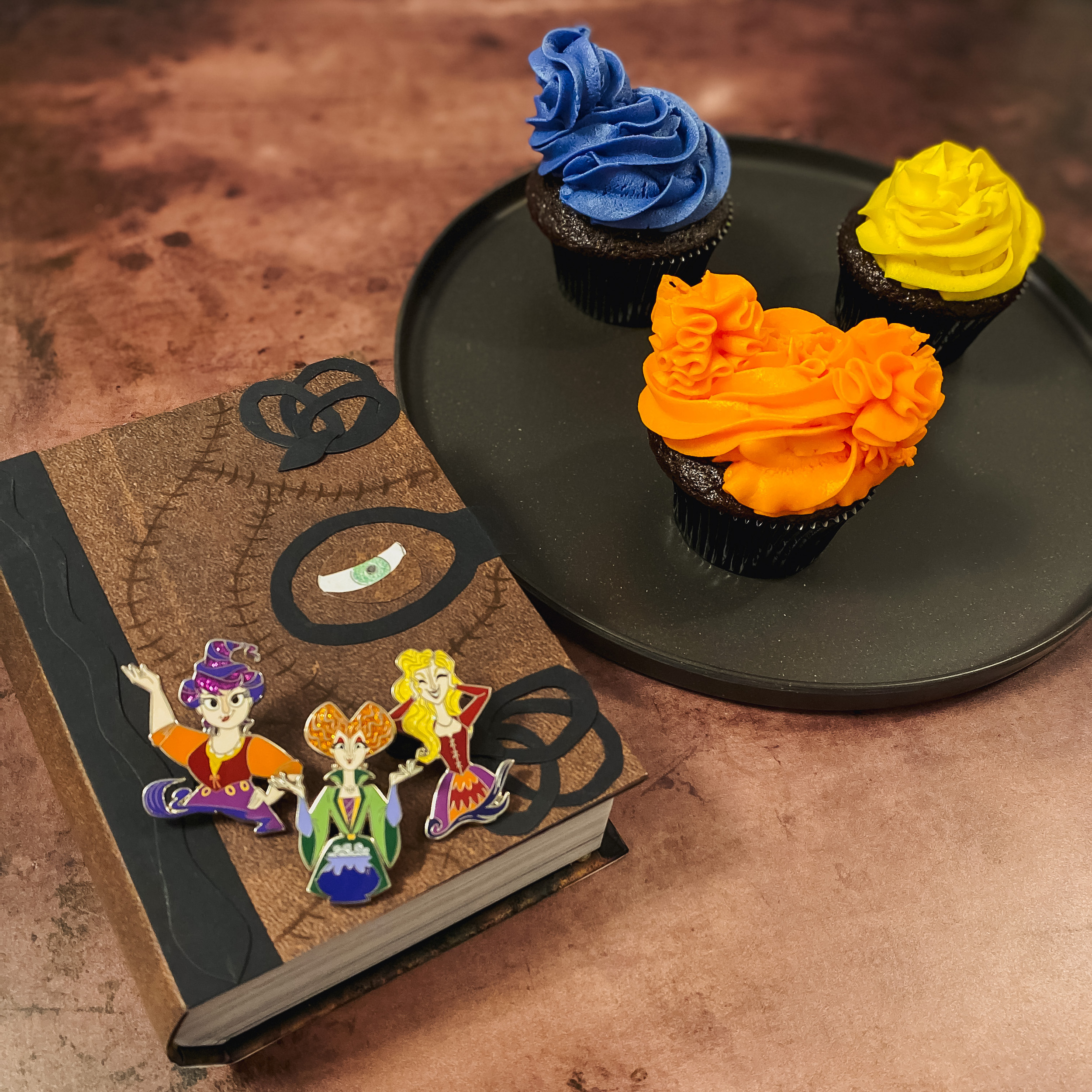 Hocus Pocus Amuck Cupcakes on a plate with Winifred's Spell Book