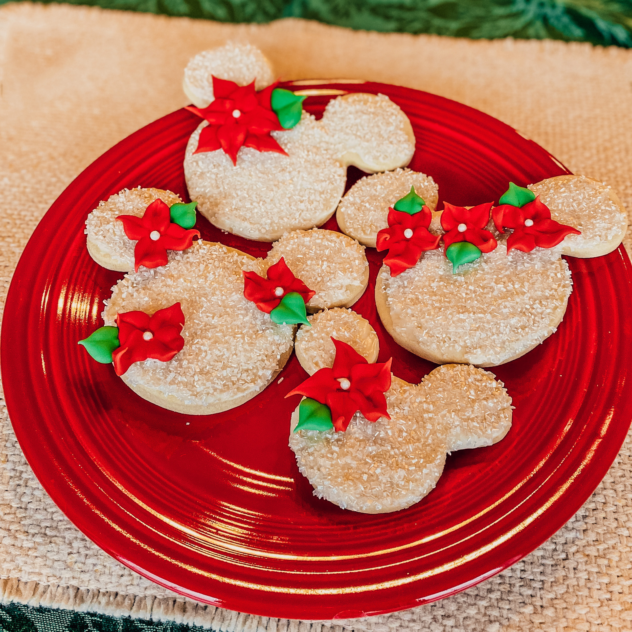 poinsettia mickey cookies on a red plate