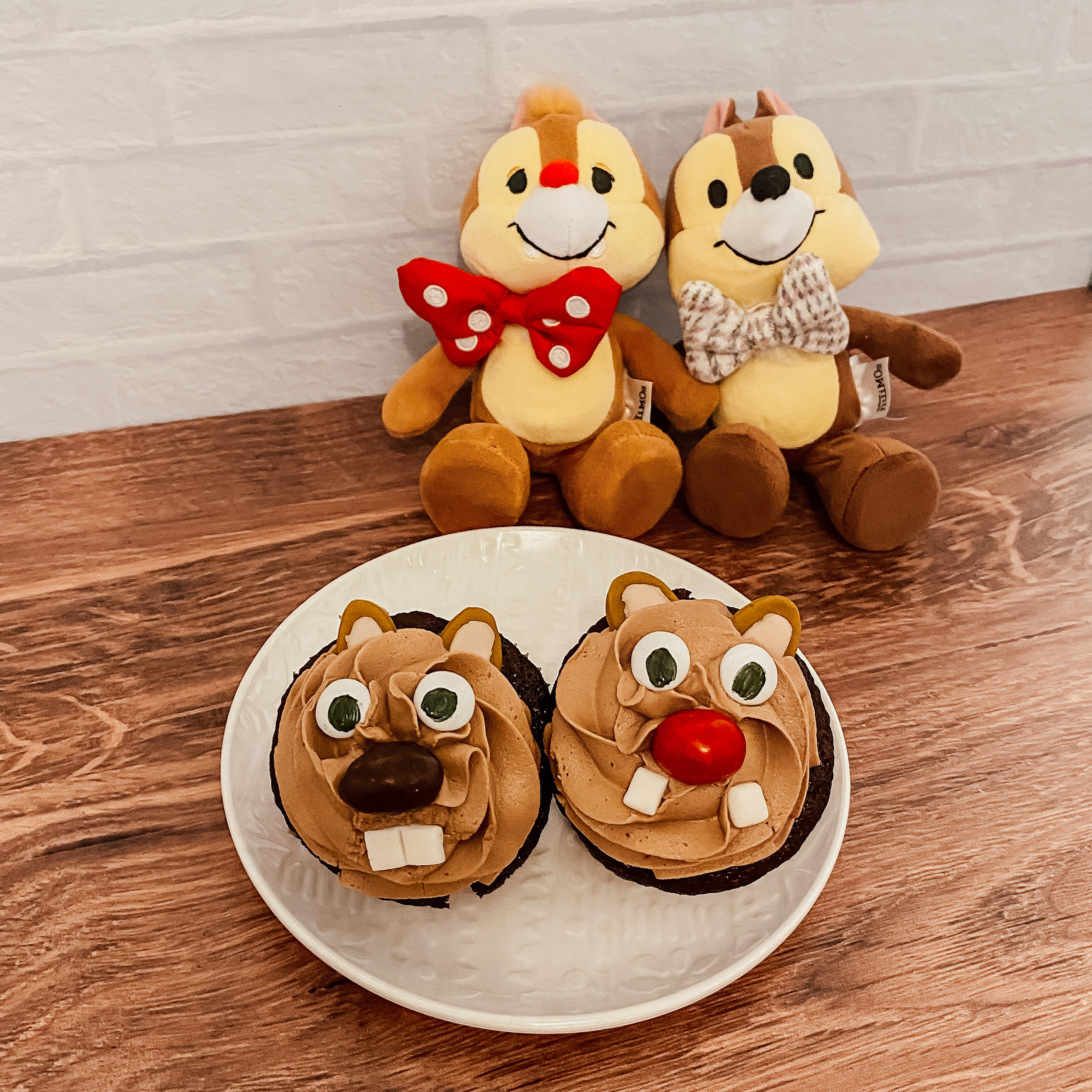 Chip 'n Dale's Nutella Cupcakes on a plate with plush Chip 'n Dales behind it