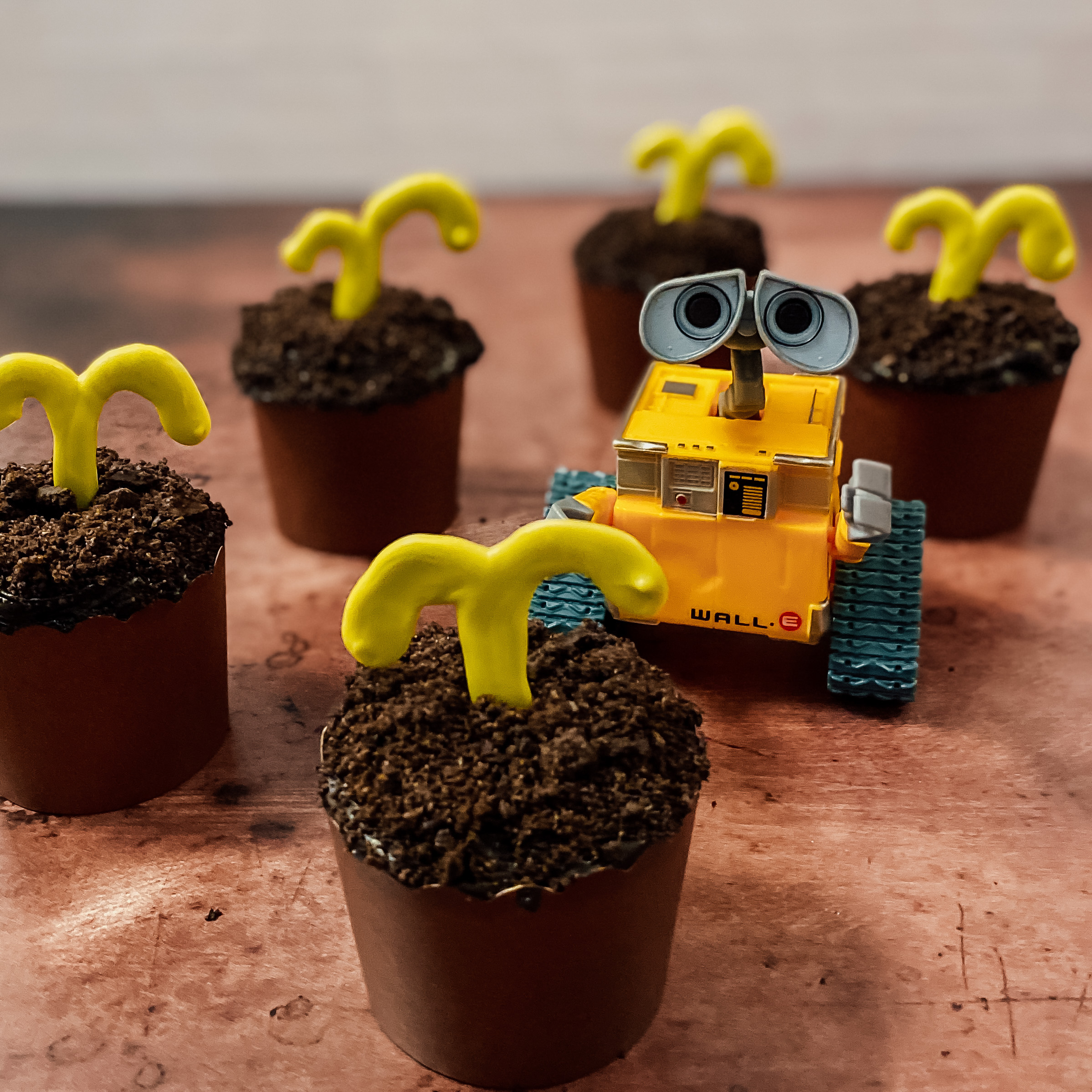 WALL-E Sprout Cupcakes (chocolate cupcakes with Oreo dirt and chocolate sprout) with a plastic figure of WALL-E