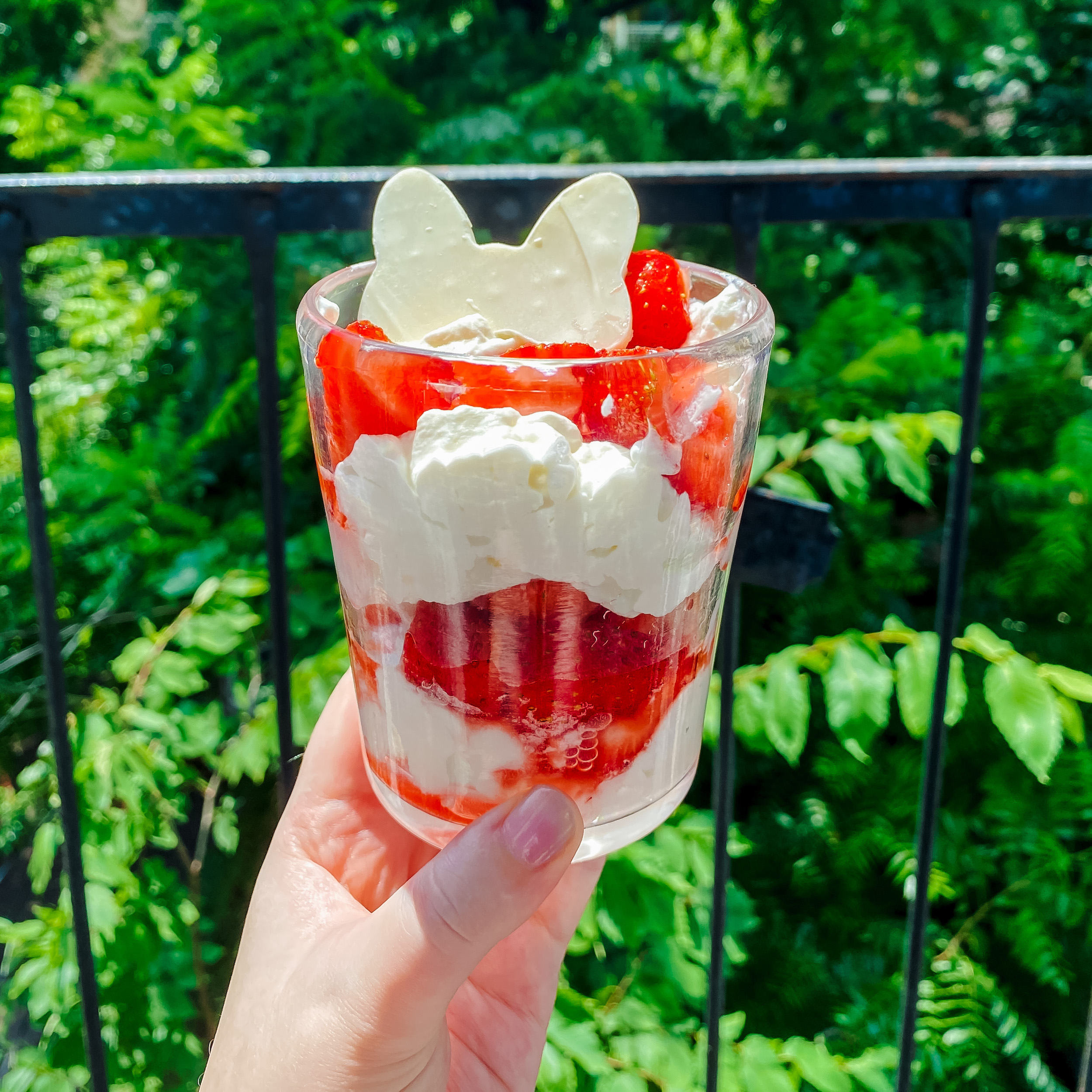 Minnie's Strawberries and Cream (a glass with layers of sliced strawberries, whipped cream, and meringue cookies, topped with a white chocolate bow)