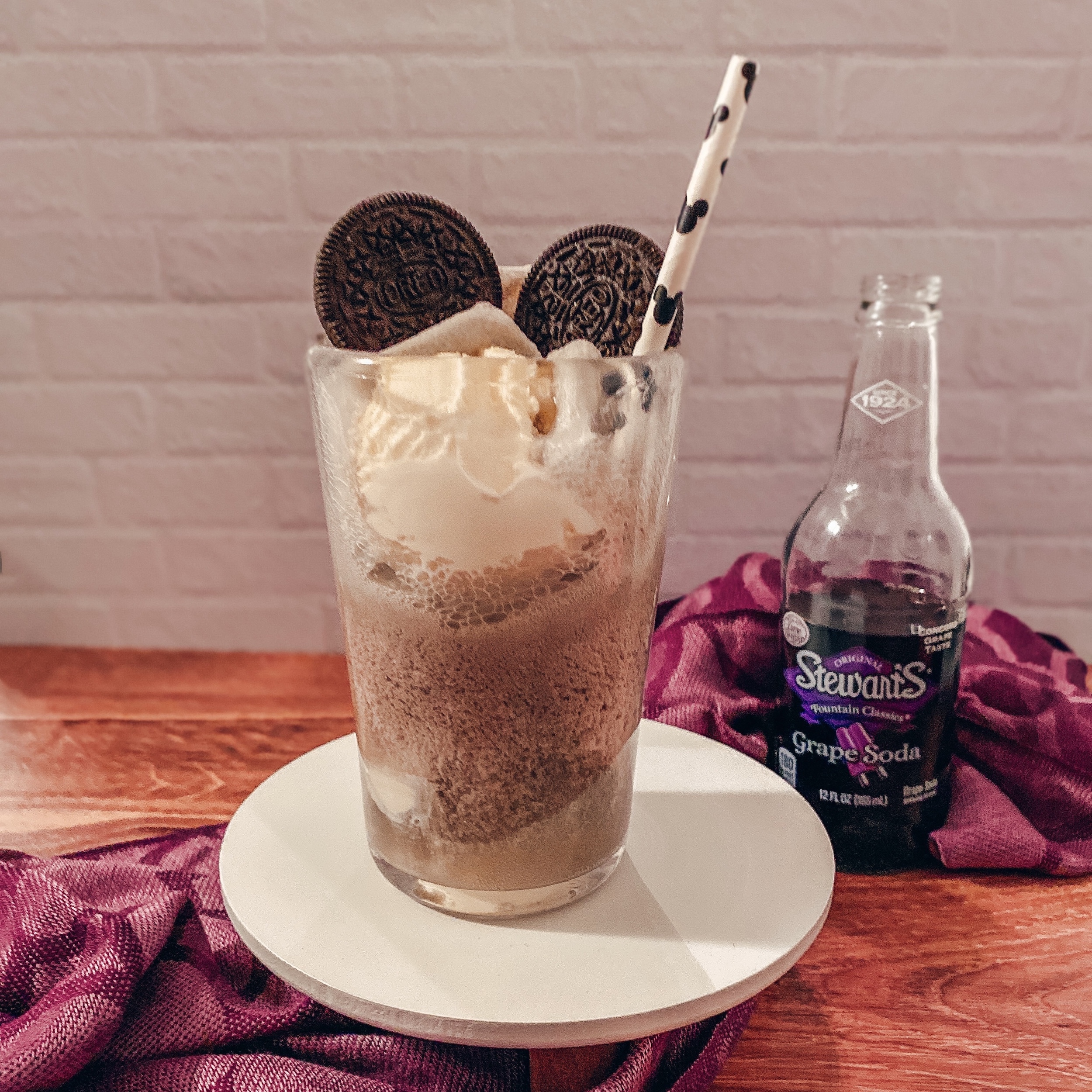 Disney100 Celebration Float (glass with vanilla ice cream, grape soda, and Oreo Mickey ears)