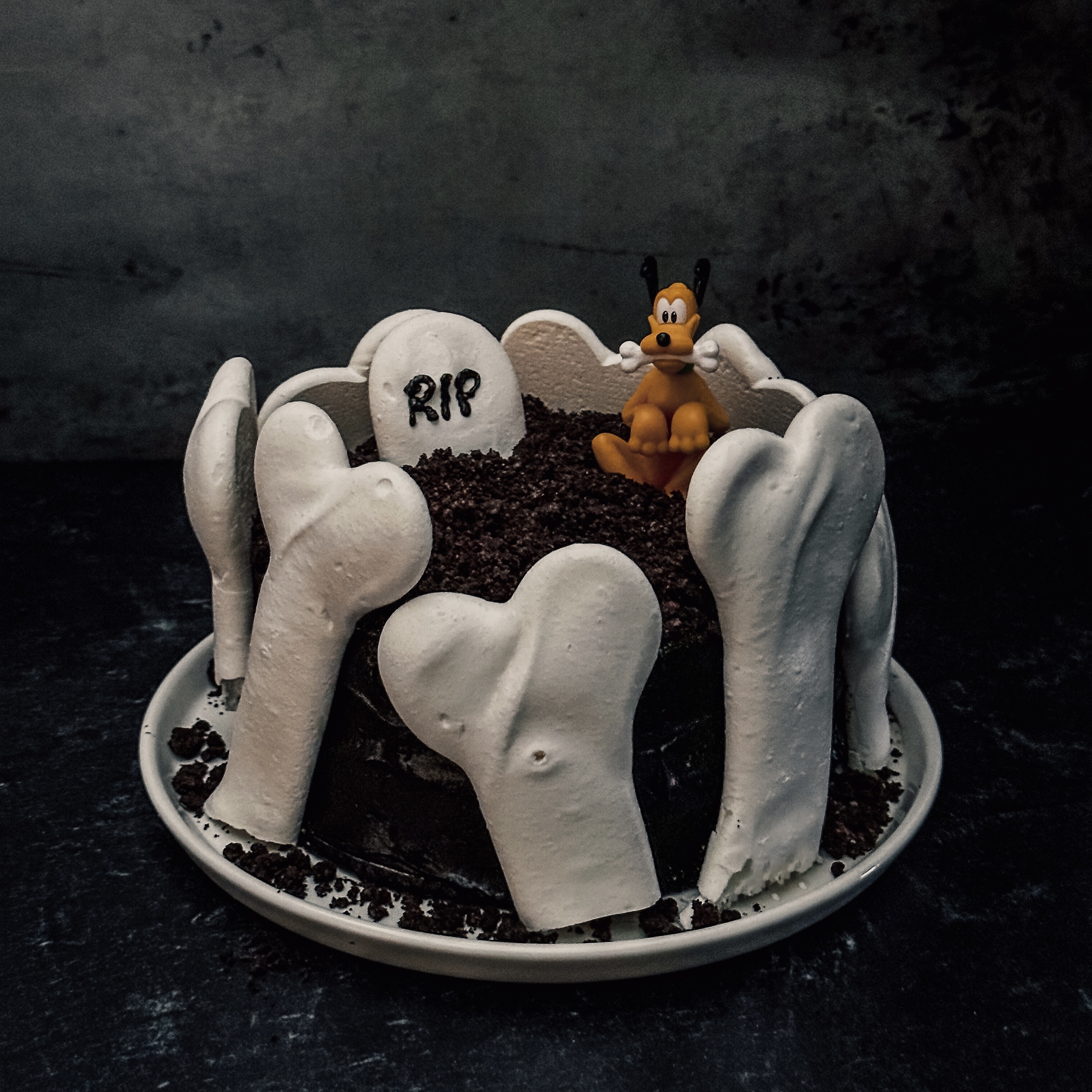 Pluto's Graveyard Cake (Black and white marble cake with black cocoa frosting, oreo crumbs, and meringue bones)