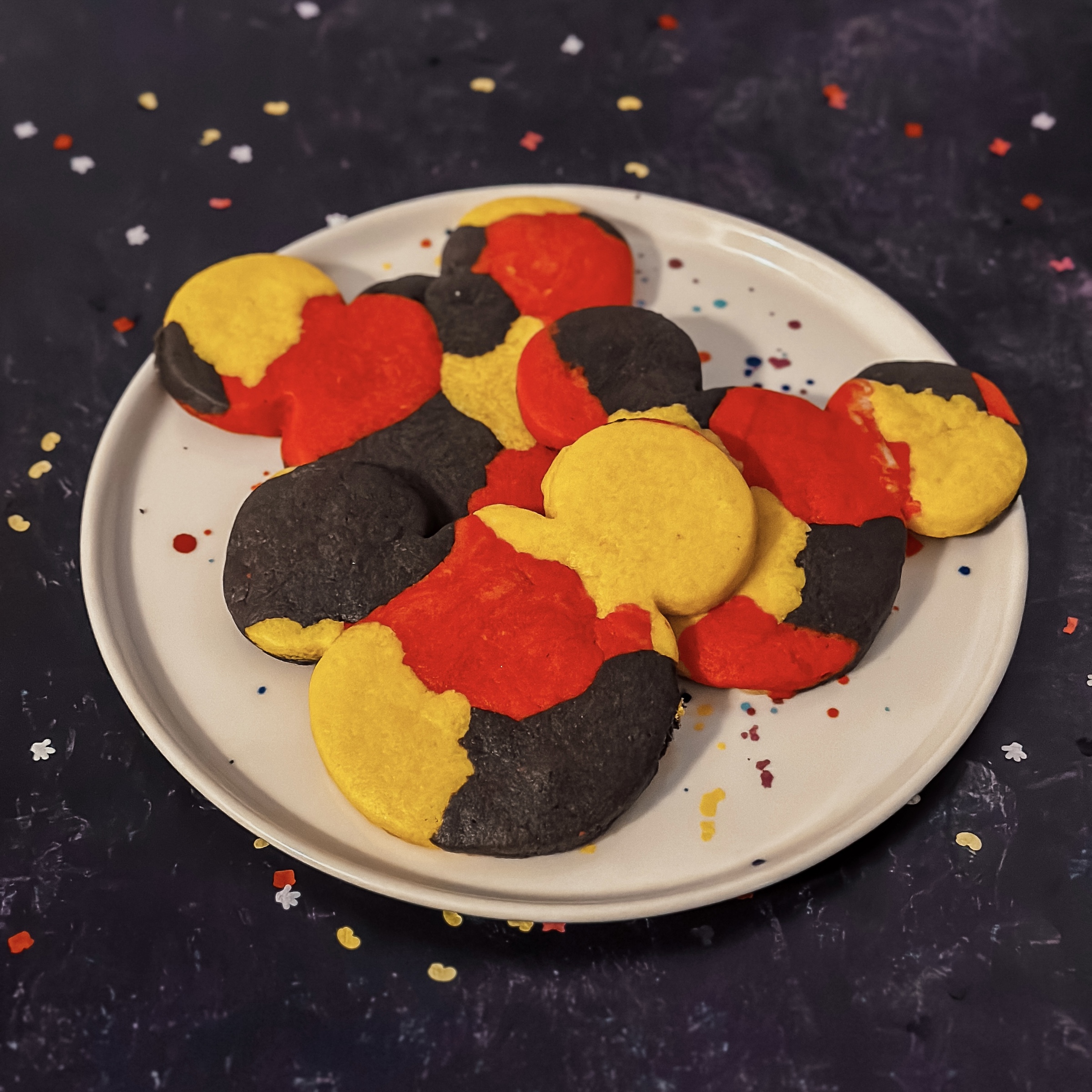 Marble Mickey Cookies (red, yellow, and black marble Mickey shaped cookies) on a plate
