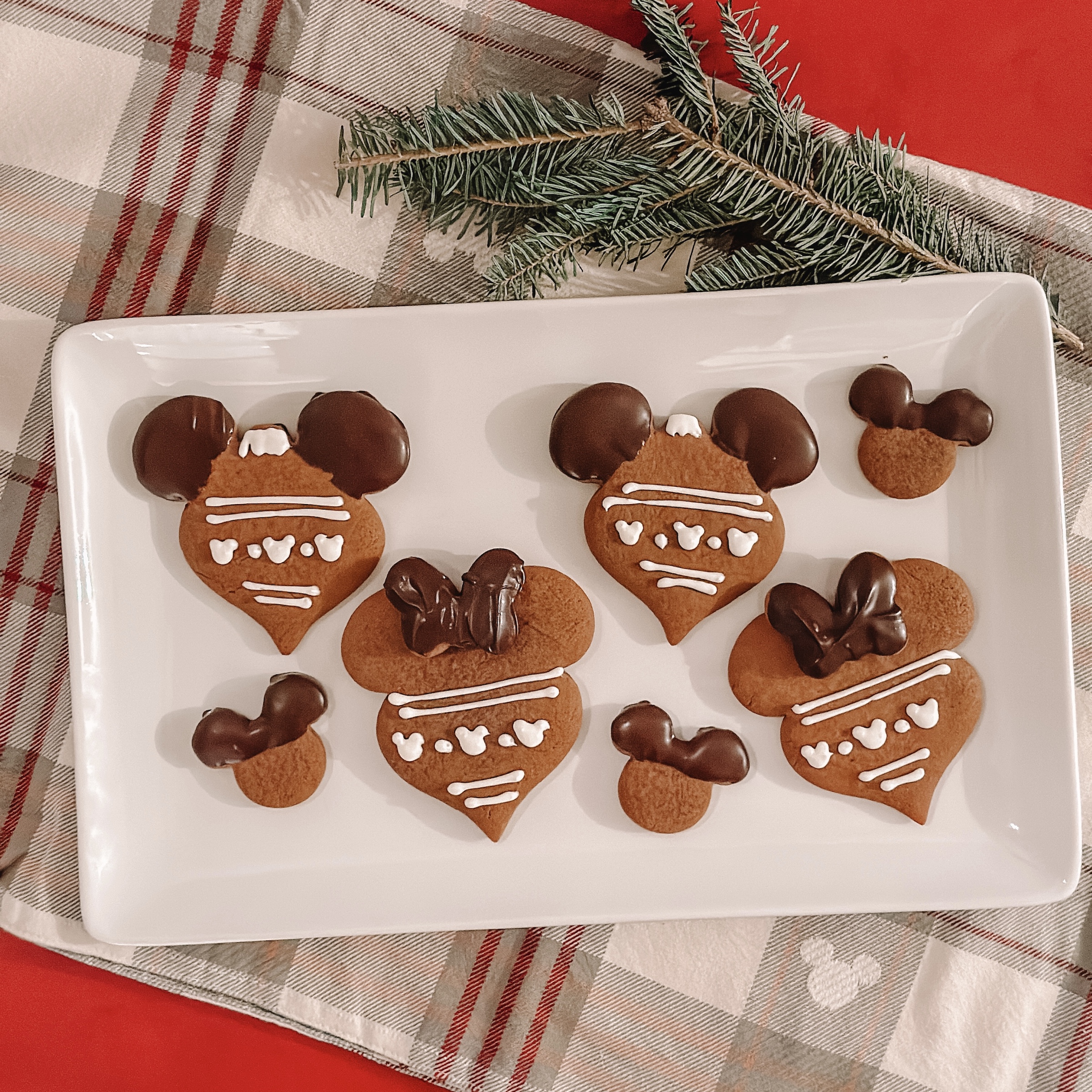 Chocolate Dipped Gingerbread Cookies (Mickey and Minnie ornament shaped gingerbread with chocolate dipped ears and bows on a platter)