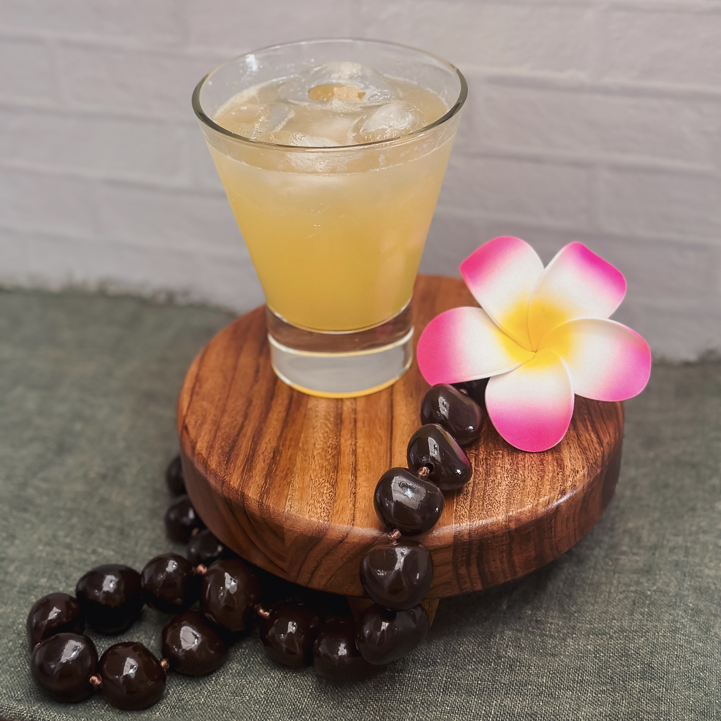 Honey-Need-List Cocktail with lei and flower